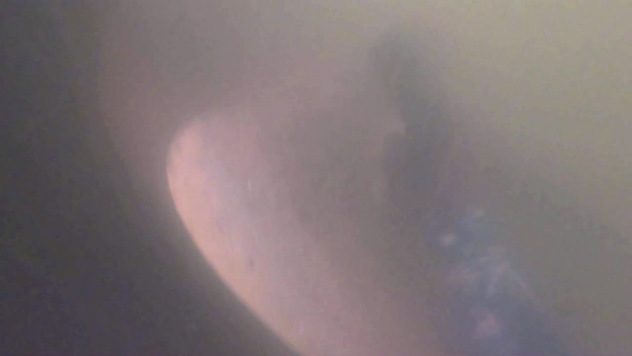 Enhanced still frame from the original after-cleaning video; visibility remains limited by murky water
